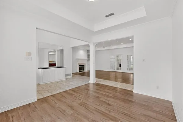 a view of a big room with wooden floor and windows