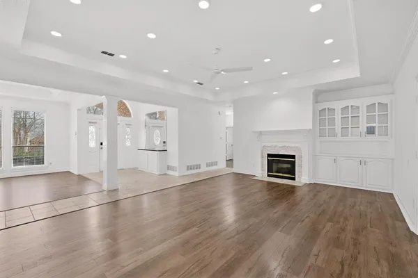 an empty room with wooden floor and fireplace