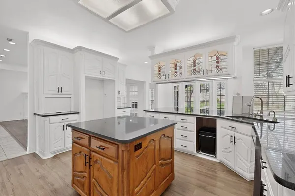 a kitchen with stainless steel appliances granite countertop a white cabinets and a stove