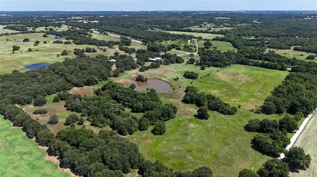 an aerial view of a houses with a yard