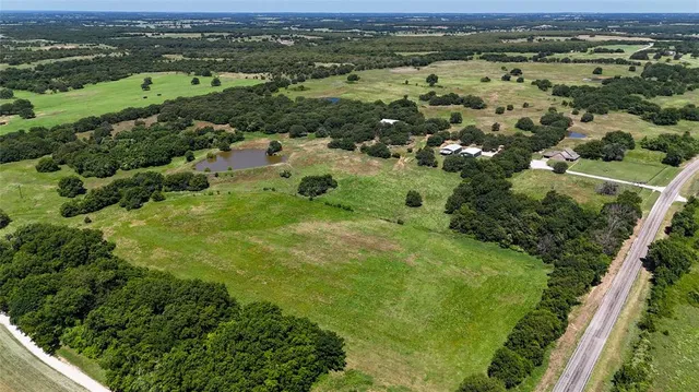 an aerial view of residential houses with outdoor space and mountain view