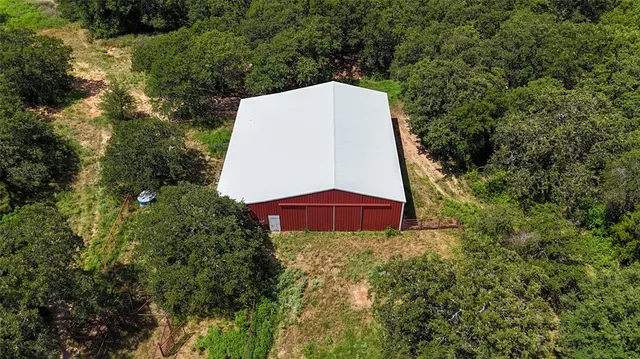 a view of a small yard with large trees