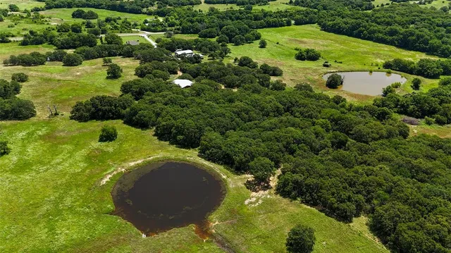 an aerial view of a house with yard swimming pool and outdoor seating