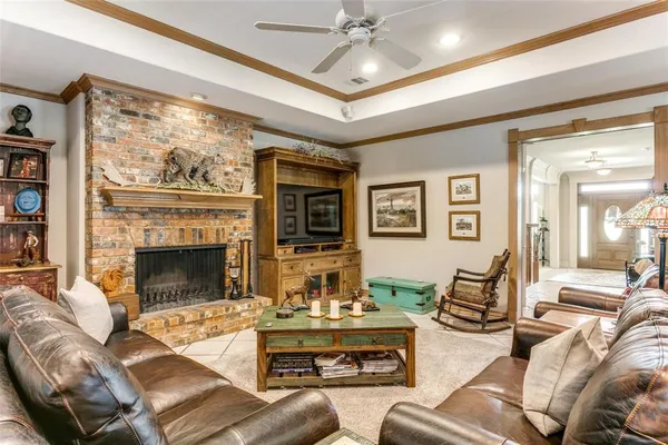 a living room with furniture a large window and a fireplace