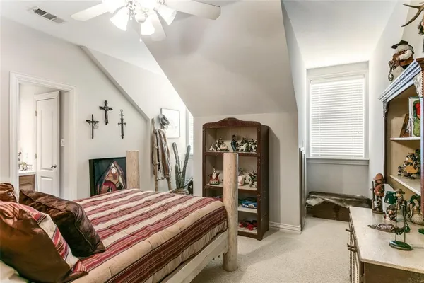 a spacious bedroom with a bed a fireplace and a window