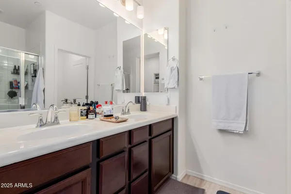 a bathroom with a sink double vanity and a mirror