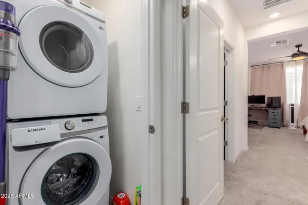 a view of a hallway with washer and dryer