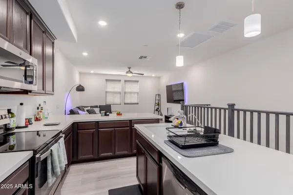 a kitchen with stainless steel appliances a sink stove and cabinets