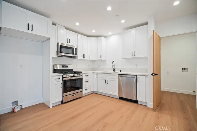 an empty room with wooden floor and a window