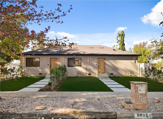 an aerial view of a house with a yard