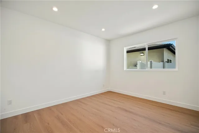 an empty room with wooden floor and closet