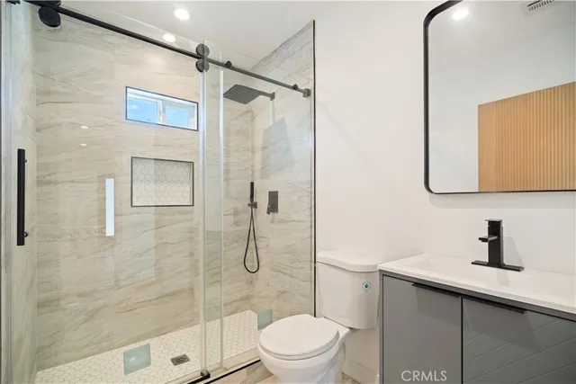 a bathroom with a toilet sink and shower