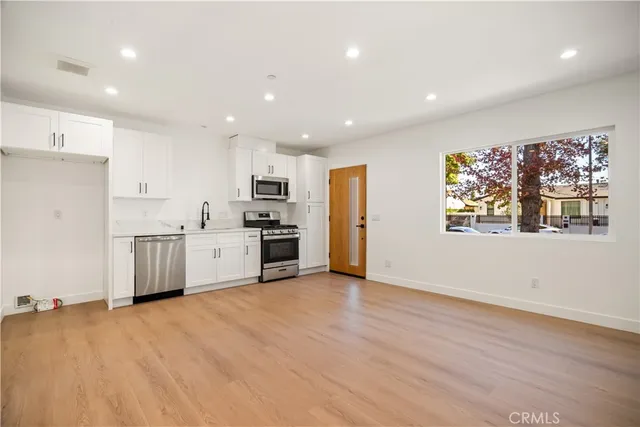 an empty room with wooden floor and closet