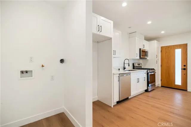 a bathroom with a toilet sink vanity and mirror
