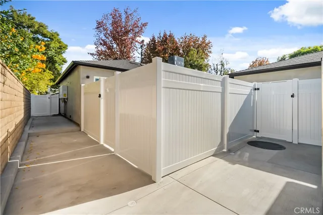 a kitchen with granite countertop white cabinets and stainless steel appliances
