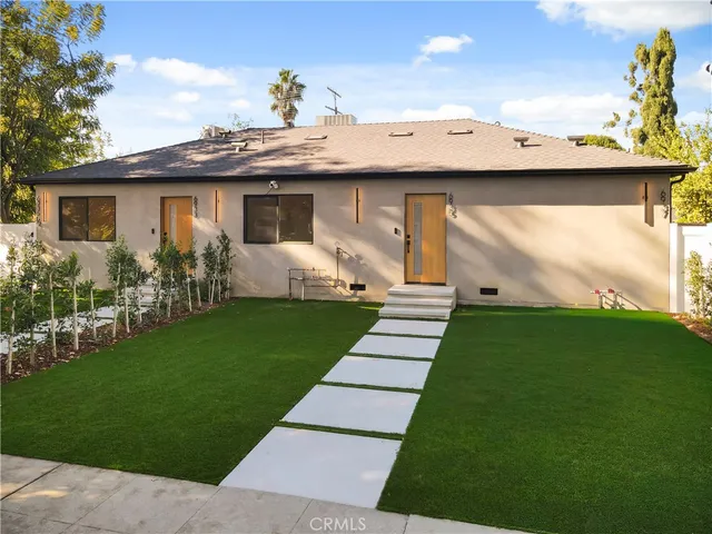 a view of kitchen with stainless steel appliances refrigerator stove microwave and cabinets