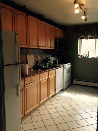 76 Bryon Road, Unit 5 Chestnut Hill, MA 02467 - Photo 1 of 10 a kitchen with stainless steel appliances a refrigerator sink and cabinets
