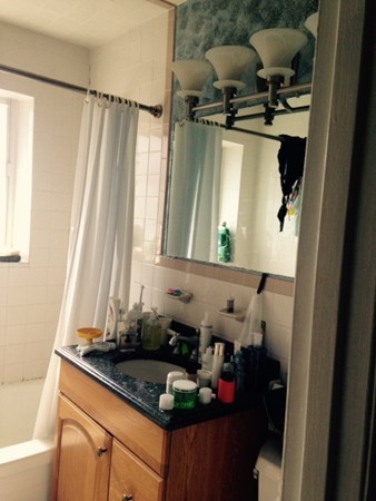 76 Bryon Road, Unit 5 Chestnut Hill, MA 02467 - Photo 3 of 10 a bathroom with a granite countertop sink and a mirror
