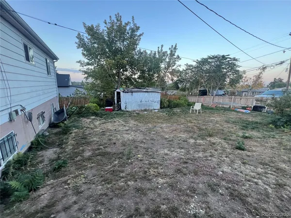 a view of a backyard with large trees