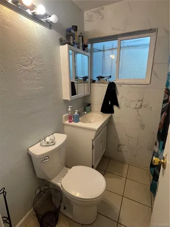 a bathroom with a toilet sink and shower