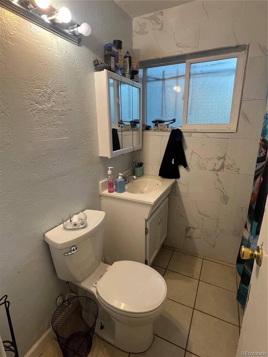 274 South Meade Street Denver, CO 80219 - Photo 6 of 14 a bathroom with a toilet sink and shower
