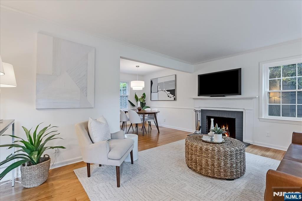 687 Grove Street Montclair, NJ 07043 - Photo 2 of 18 a living room with furniture a fireplace and a flat screen tv