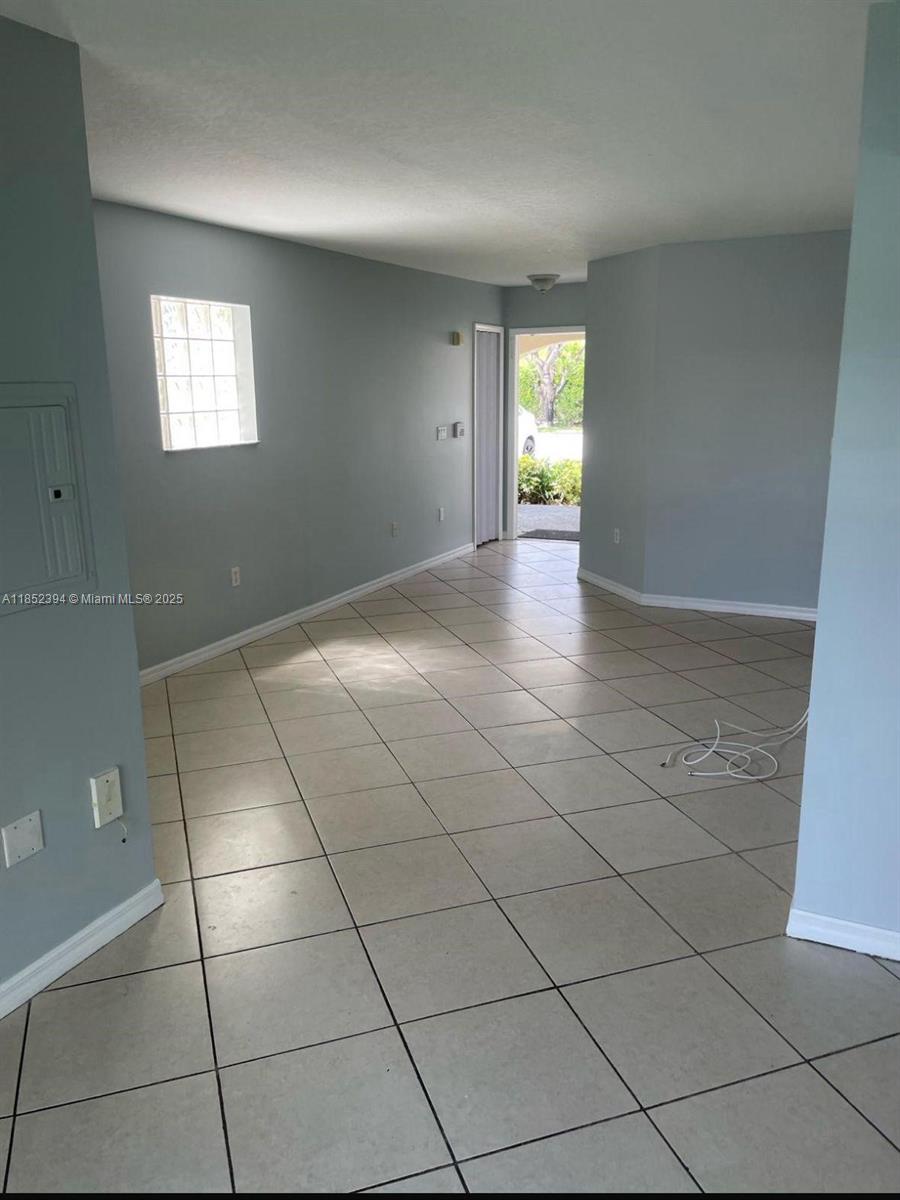 2701 Southeast 12th Road, Unit 106 Homestead, FL 33035 - Photo 12 of 21 a view of an empty room and window