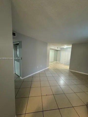 a view of an empty room and a window