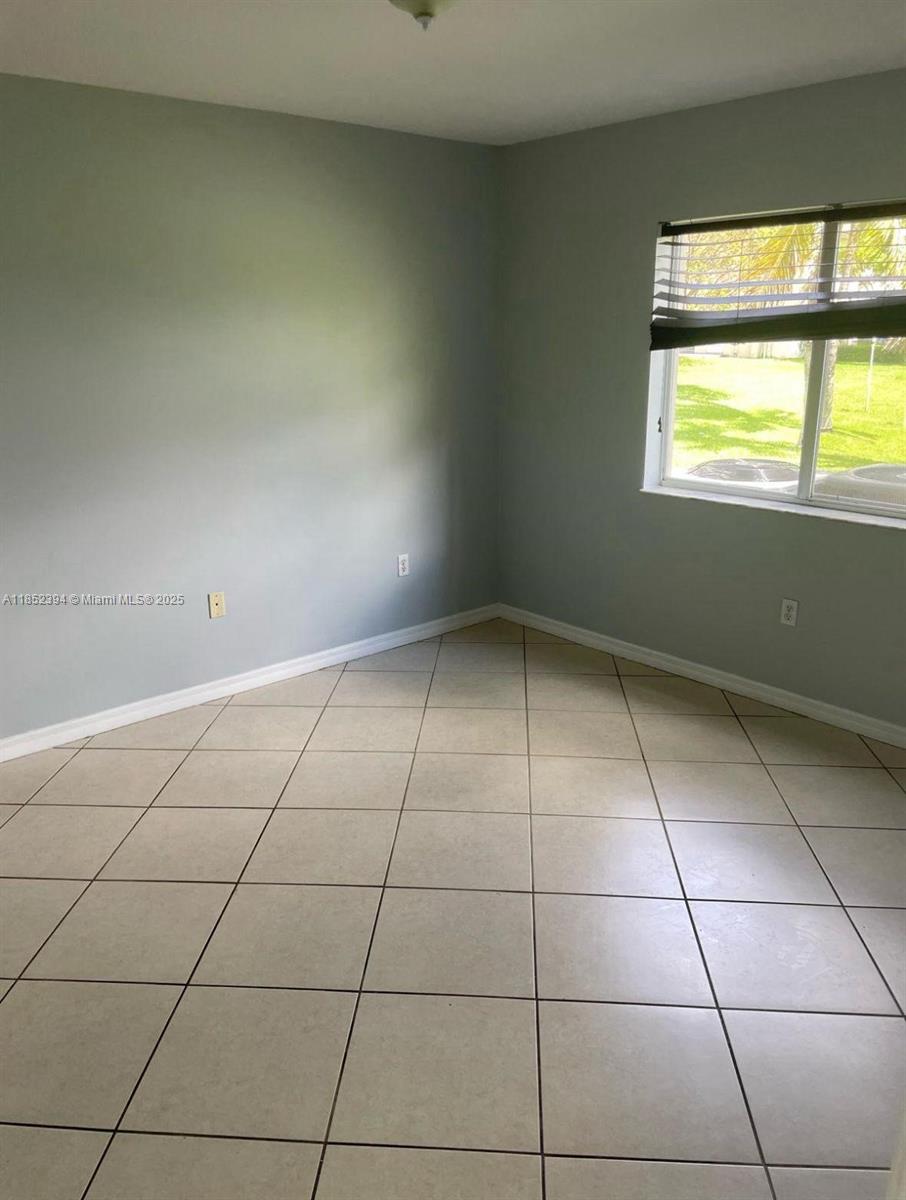 2701 Southeast 12th Road, Unit 106 Homestead, FL 33035 - Photo 14 of 21 a view of an empty room and window