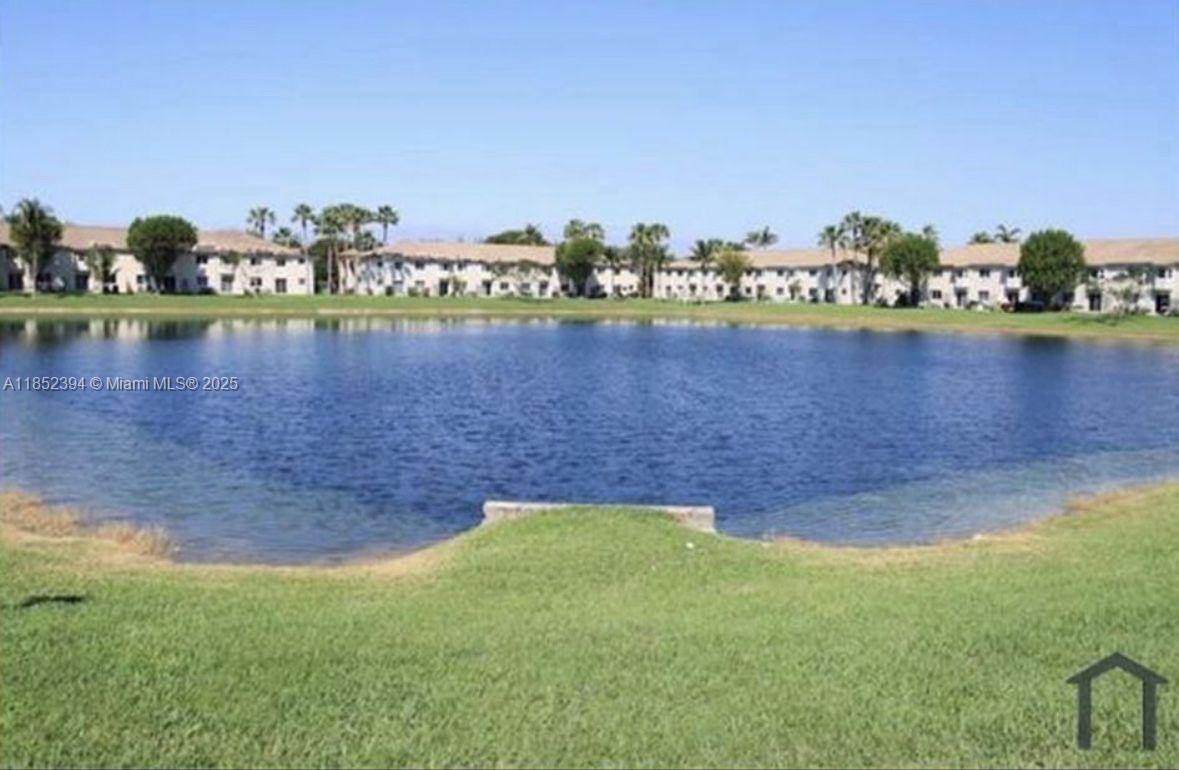 2701 Southeast 12th Road, Unit 106 Homestead, FL 33035 - Photo 4 of 21 a view of a lake with houses