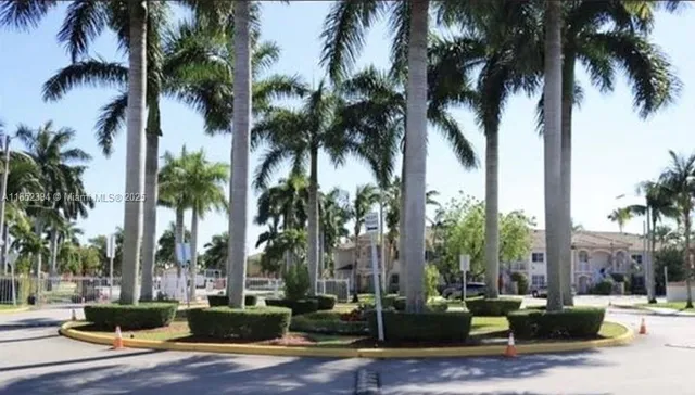 a row of palm trees and a swimming pool