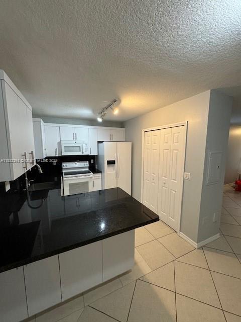 2701 Southeast 12th Road, Unit 106 Homestead, FL 33035 - Photo 9 of 21 a kitchen with stainless steel appliances a refrigerator sink and cabinets