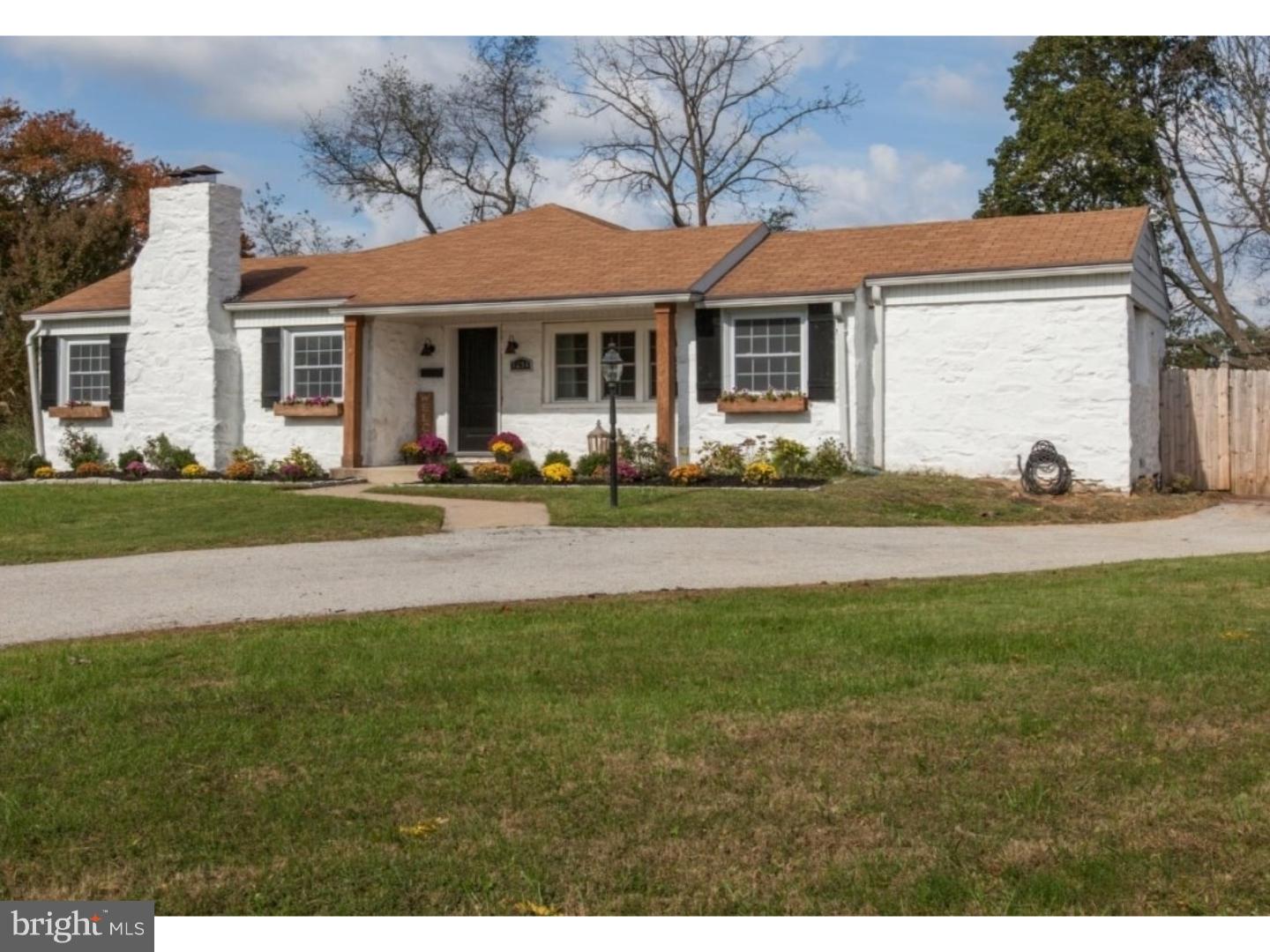 a front view of a house with a garden and patio