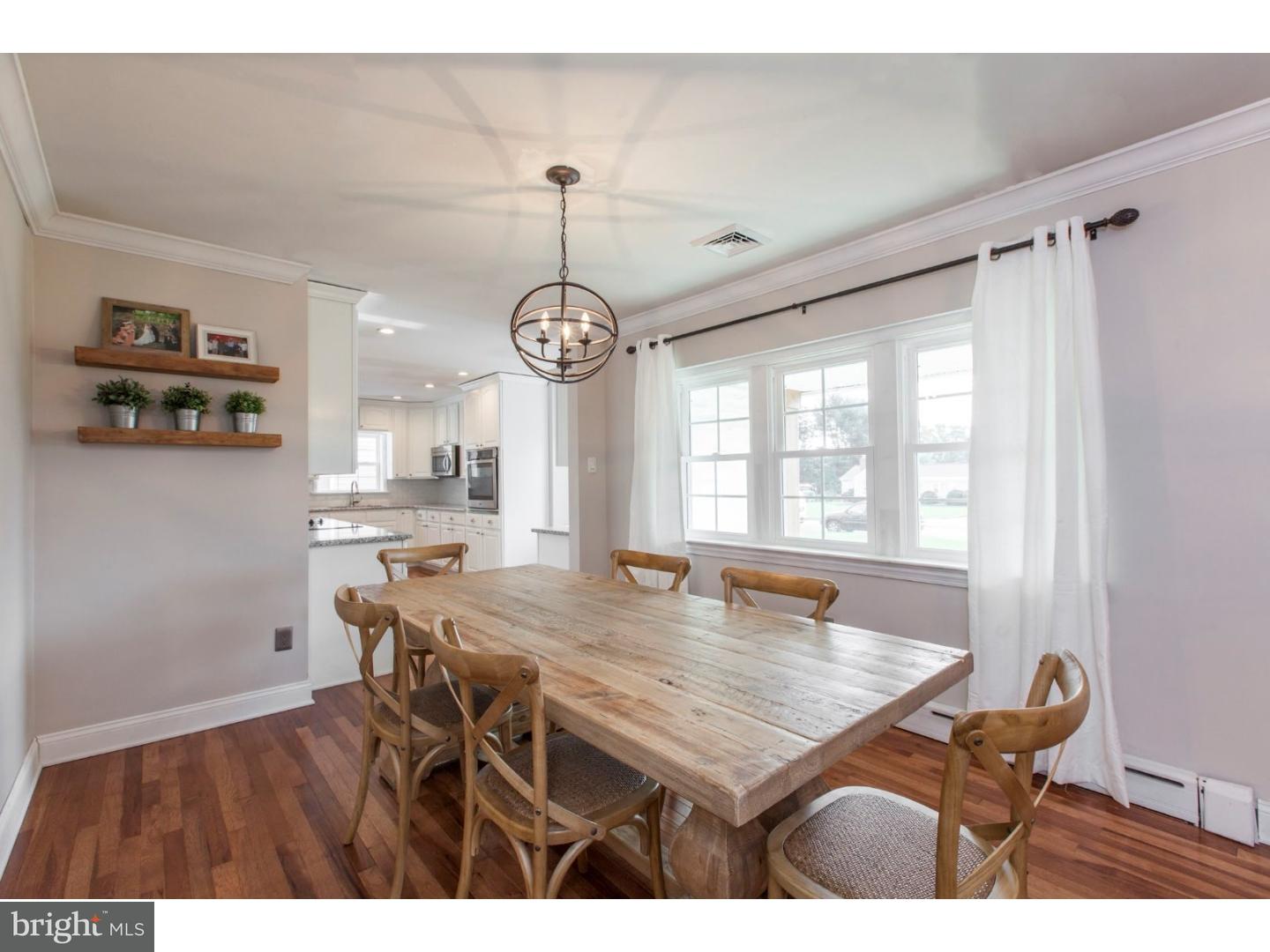 1238 Dill Road Havertown, PA 19083 - Photo 13 of 23 a view of a dining room and livingroom with furniture wooden floor a rug a painting and a chandelier