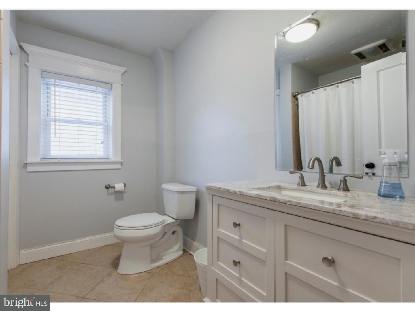 1238 Dill Road Havertown, PA 19083 - Photo 18 of 23 a bathroom with a granite countertop sink toilet and mirror