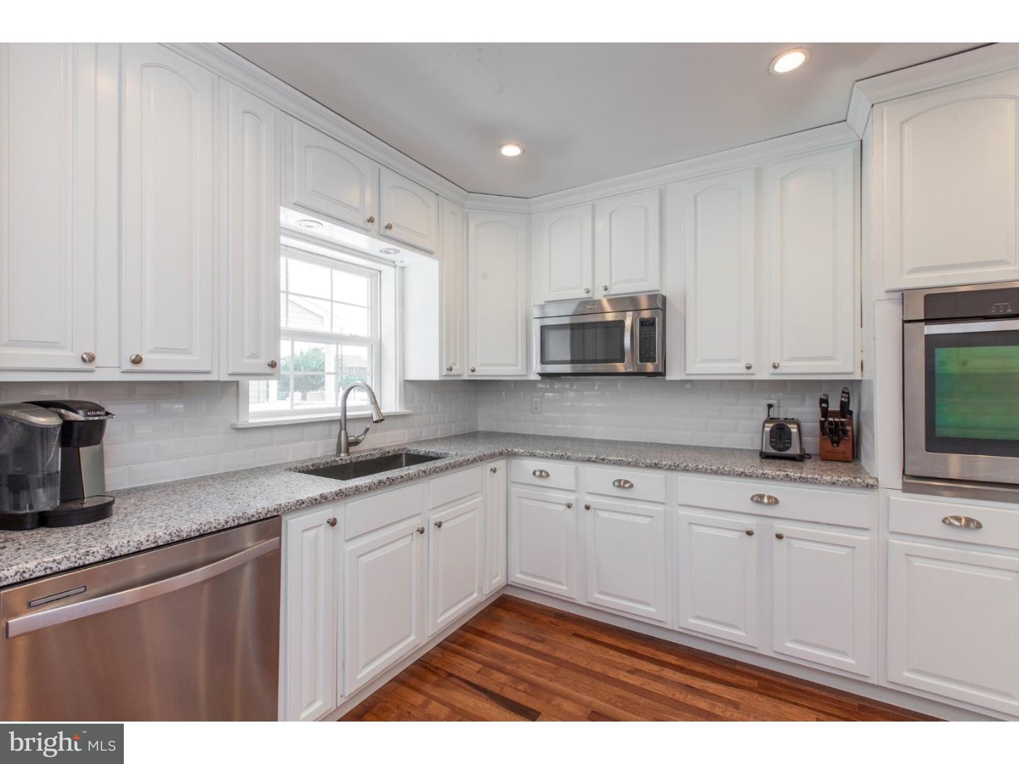 1238 Dill Road Havertown, PA 19083 - Photo 6 of 23 a kitchen with granite countertop white cabinets and white appliances