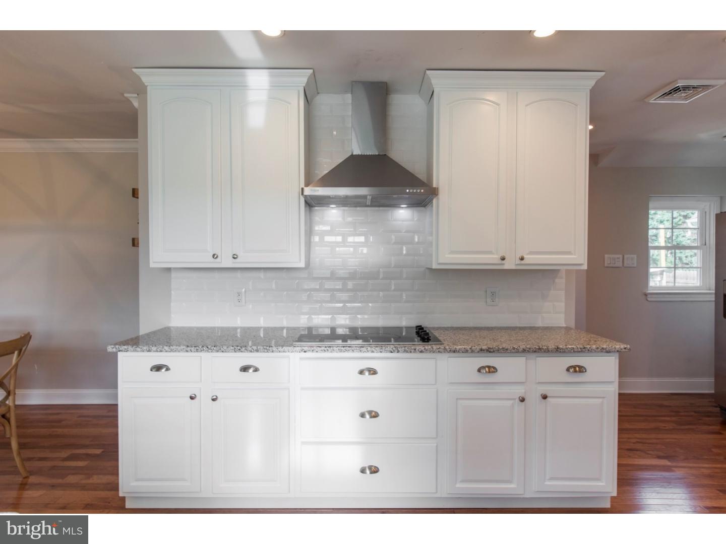 1238 Dill Road Havertown, PA 19083 - Photo 8 of 23 a kitchen with granite countertop white cabinets and stainless steel appliances