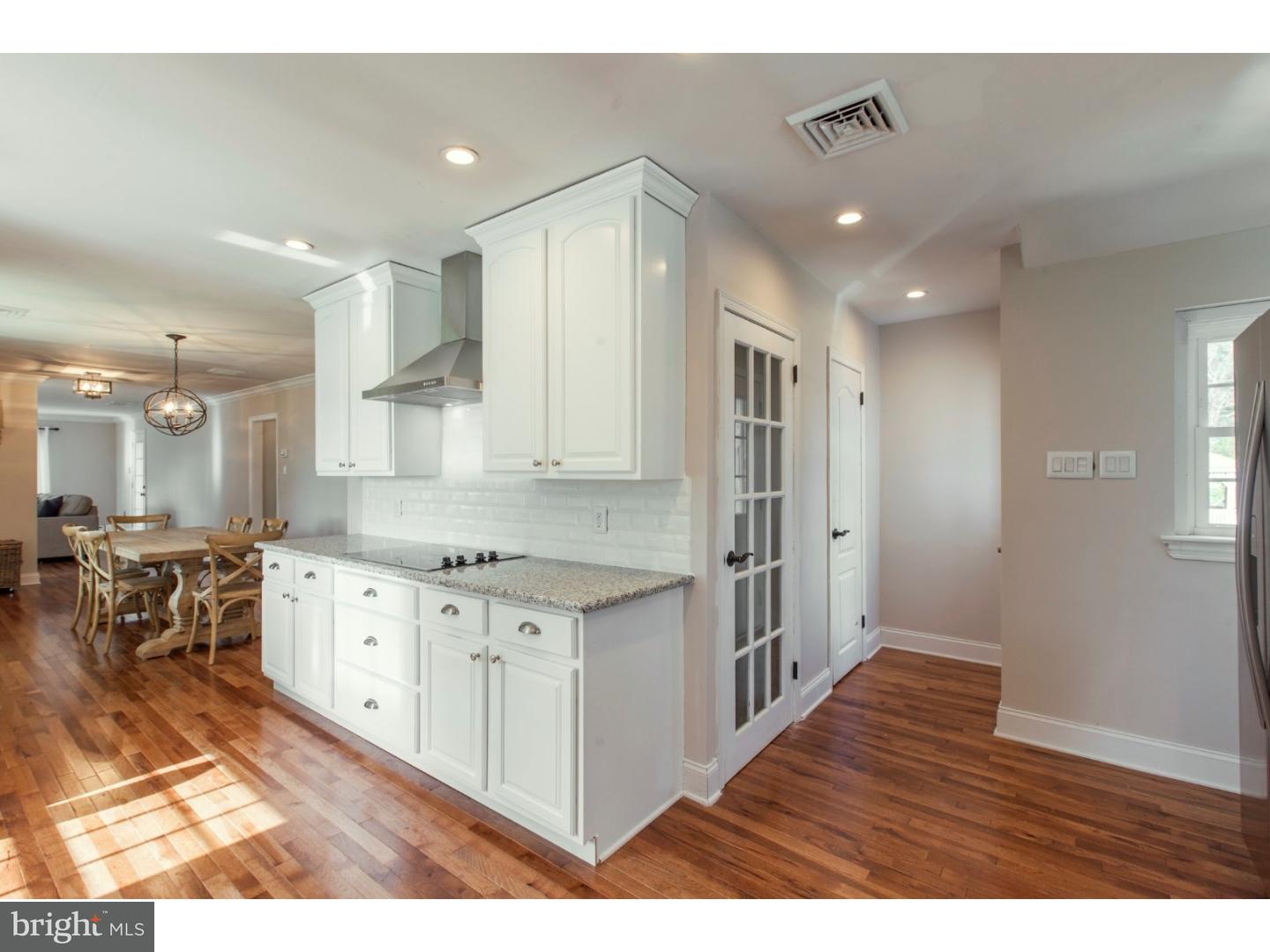 1238 Dill Road Havertown, PA 19083 - Photo 9 of 23 a kitchen with stainless steel appliances granite countertop a refrigerator a sink dishwasher and white cabinets with wooden floor