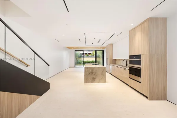 a kitchen with appliances cabinets and furniture
