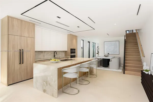 a kitchen with stainless steel appliances a refrigerator and a stove