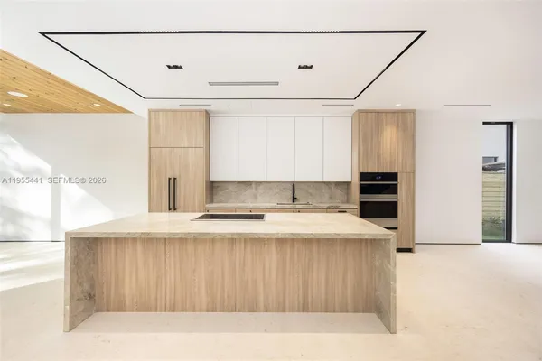 a view of kitchen with stainless steel appliances granite countertop cabinets and a counter top