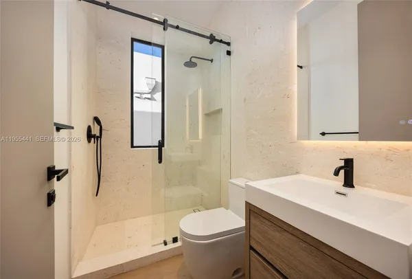 a bathroom with a toilet and a shower
