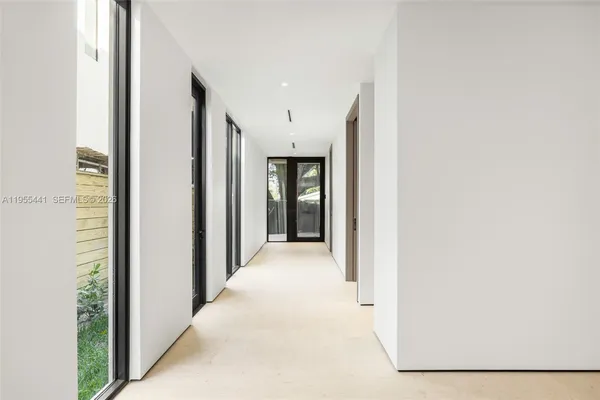 a view of a hallway with wooden shelves