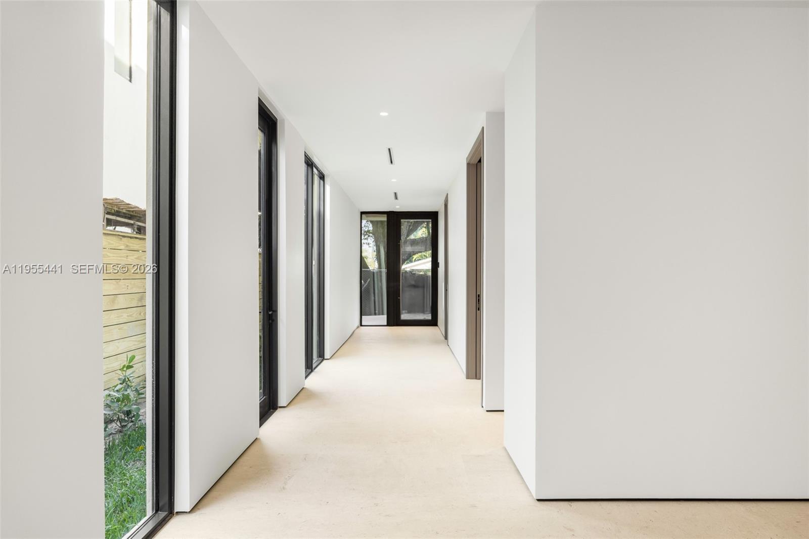 3144 Elizabeth Street Coconut Grove, FL 33133 - Photo 3 of 39 a view of a hallway with wooden shelves