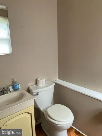 a white toilet sitting next to a bathroom sink