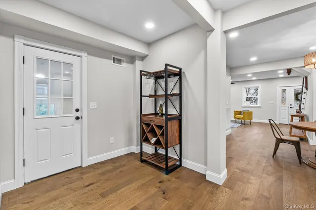a view of an empty room and wooden floor