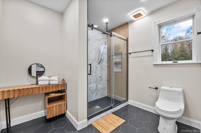 a bathroom with a toilet a sink and shower