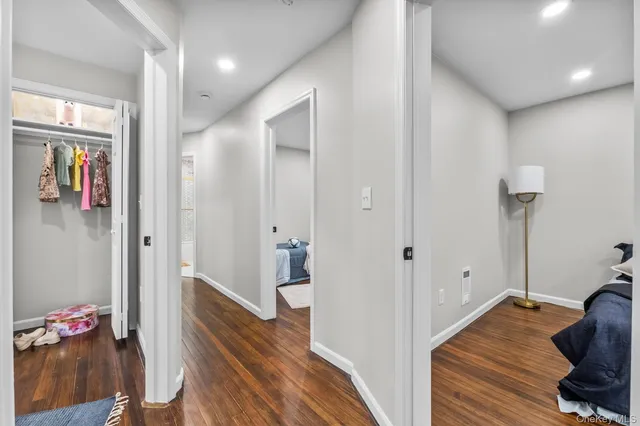 a view of hallway with wooden floor