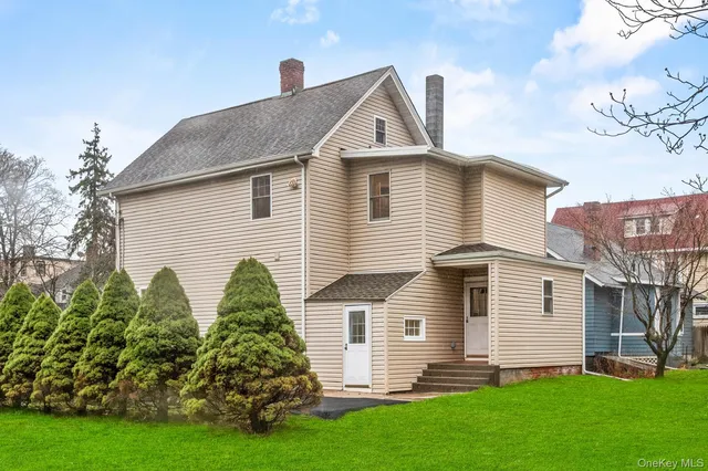 a front view of a house with a garden