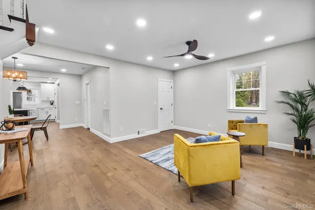 a living room with furniture and kitchen view